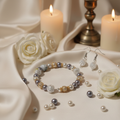 Silver Mist Pearl and Floral Bracelet Set on elegant grey and gold background with white roses